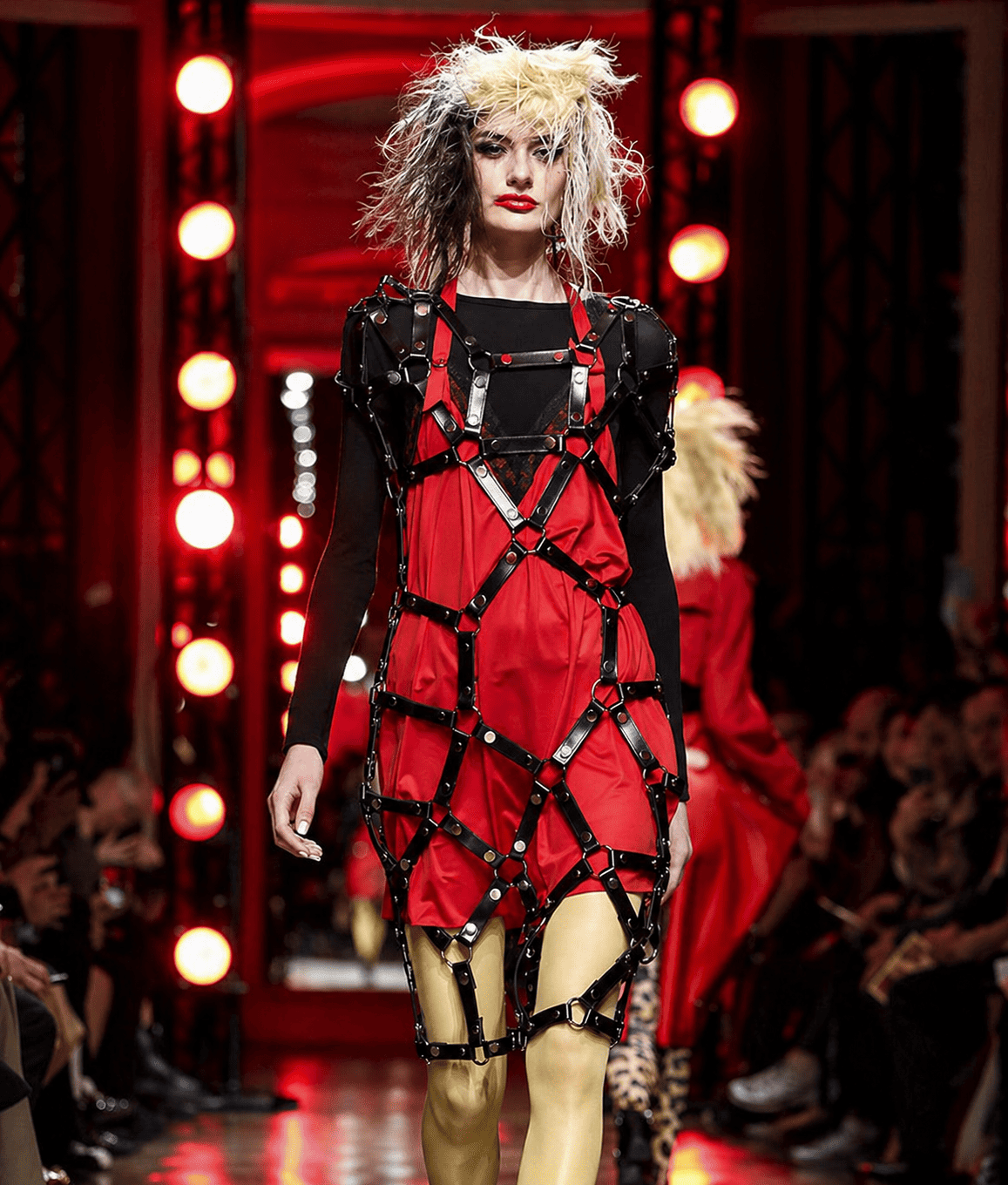 High-fashion runway in red-lit drama